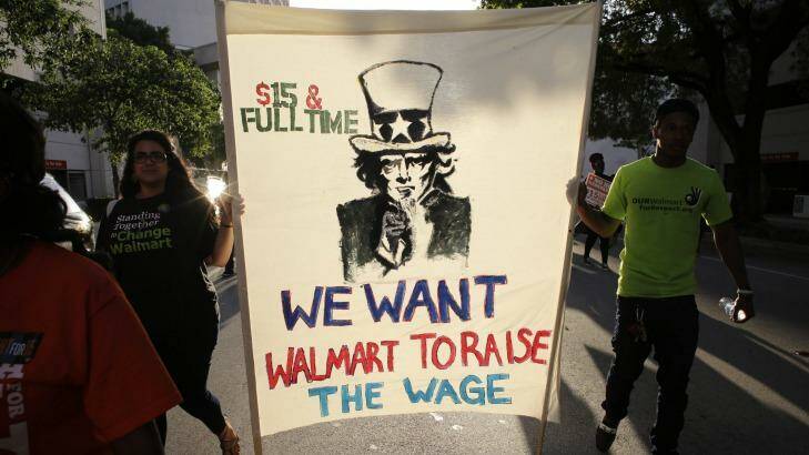Protesters in Miami march in support of raising the minimum wage to $US15 an hour. Hillary Clinton, with an eye to her party's left wing, has placed an early emphasis on social equity. Photo: AP 