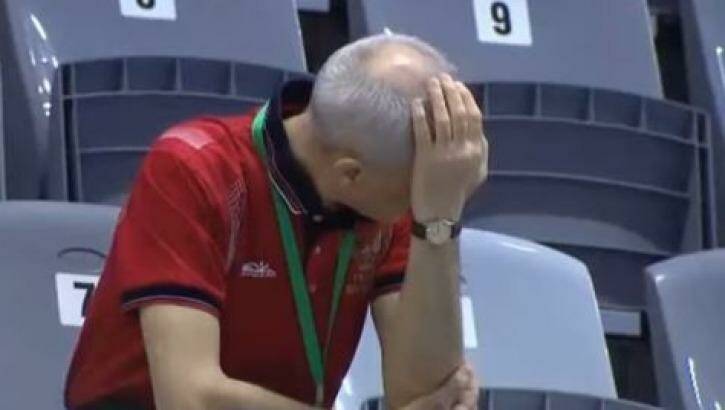 Ouch: The divers' coach reacts to the failed attempt.