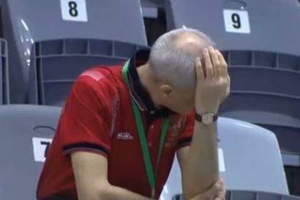 Ouch: The divers' coach reacts to the failed attempt.