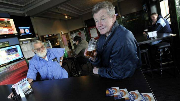 Merv Hall (left) and Billy Hackett lament the fact that men outnumber women in Junee over beers at the Commercial Hotel. Photo: Les Smith