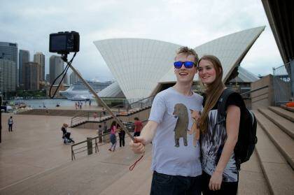 Tourists using selfie sticks. Alex Kyling and Linda Keizer use a selfie stick at the Opera House. Photo: Wolter Peeters