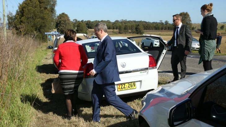 Bill Shorten goes to his car to comfort the woman involved in the crash. Photo: Max Mason Hubers