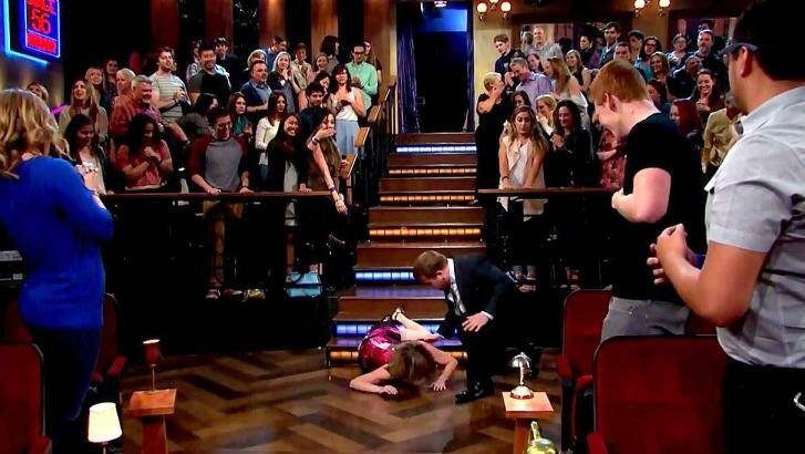 A horrified <i>Late Late Show</i> host James Corden rushes to Katie Couric's side. Check out the mixed faces in the audience. Photo: YouTube
