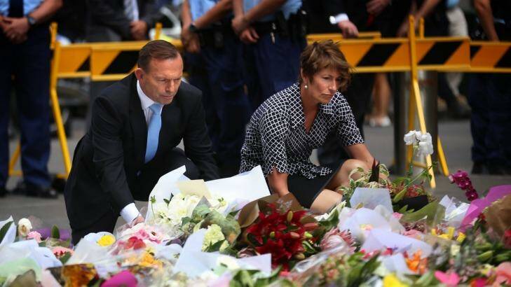 Prime Minister Tony Abbott and wife Margie left flowers at the makeshift memorial at Martin Place. Photo: James Alcock