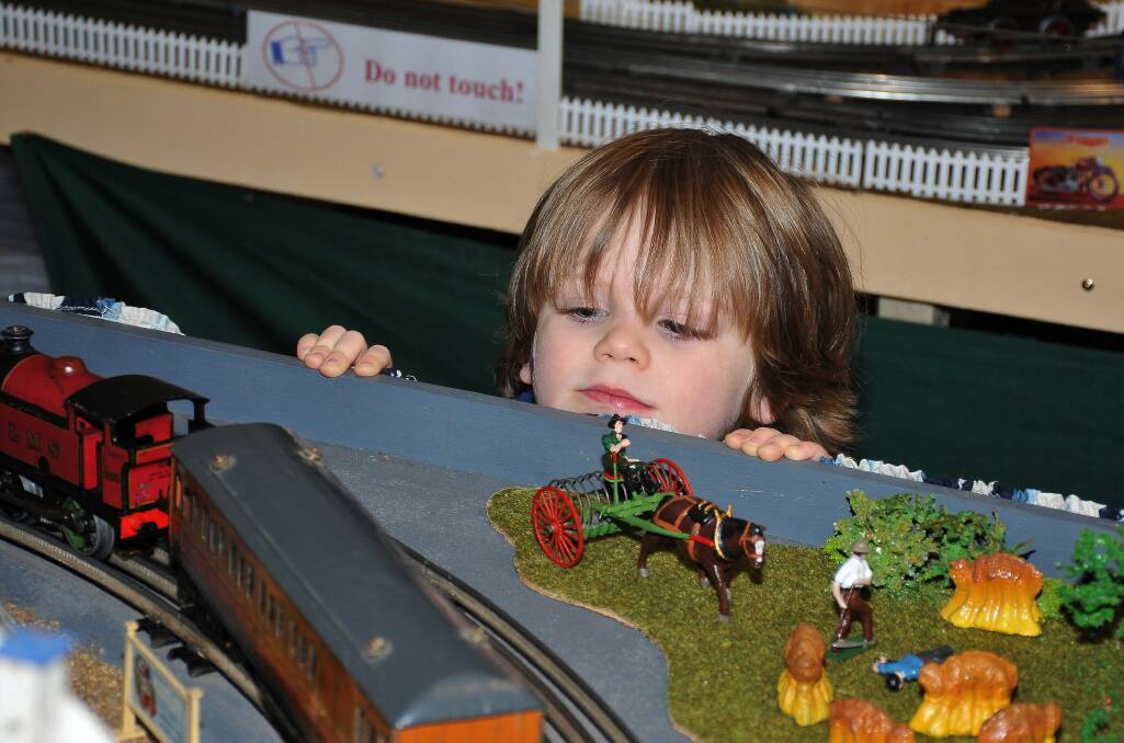 Oscar Summers couldn't get close enough to the model railroad displays, which
had everything from farmyards to a working circus. Picture: MARK McMILLAN
