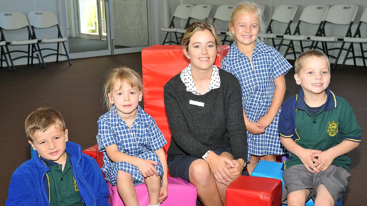 One of the new teachers at St Patrick’s Primary School, Georgia Cain, is pictured helping new preps, Charlie, Eve, Alice and Christian, settle into their new environment. Picture: KERRI KINGSTON.