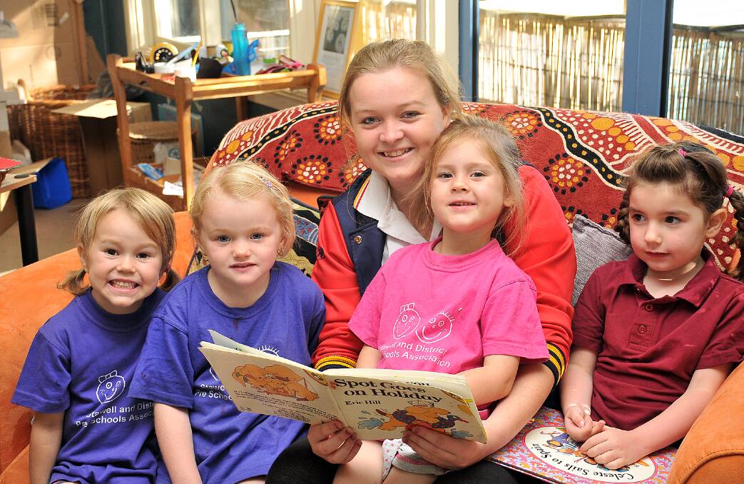 Hayley O'Neill reading to Kinder youngsters Chloe, Tess, Teepika and Ava at Cooinda Kindergarten. Picture: KERRI KINGSTON.