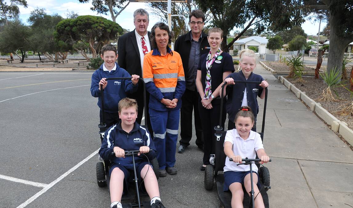 Pushcart sponsors and students (back) Cr Murray Emerson, Meg Parnaby (Stawell Gold Mine), John Teasdale (Choices Flooring by Westside), Caitlin Cooper (Specsavers); (front) Charlie, Sam, Elizabeth and Phoebe.