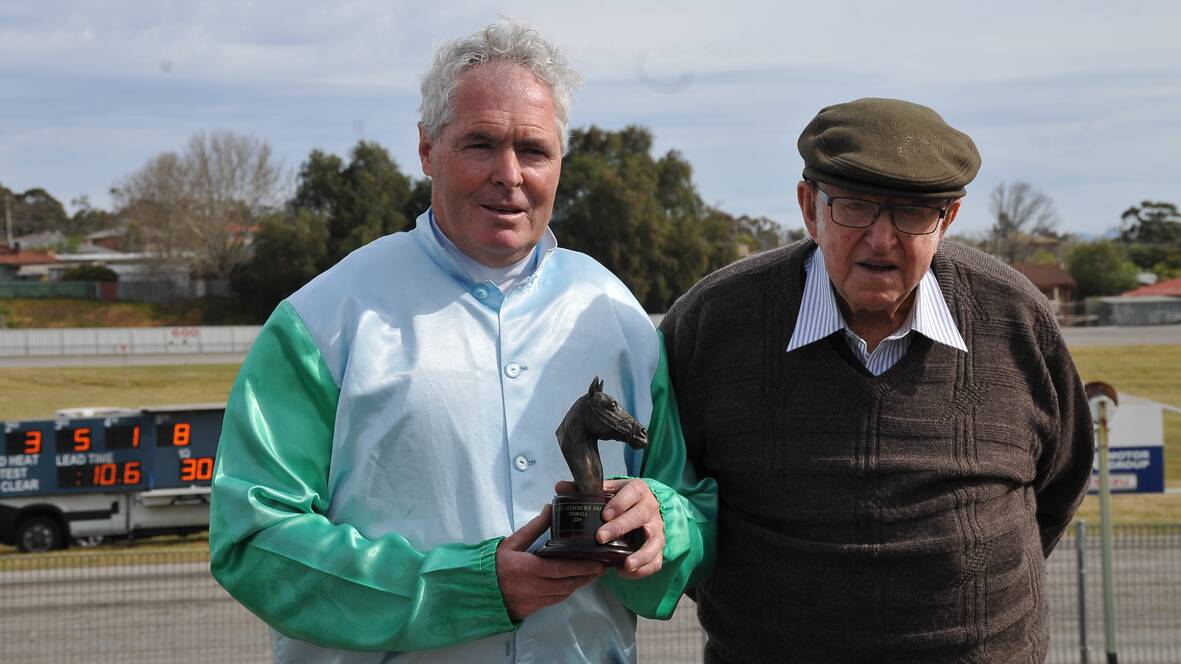 Trainer/Driver Tony Bond (left) received the winning trophy from Stawell Harness Racing Club life member Reg Cooper after Game Cullen’s victory. Picture: BEN KIMBER.