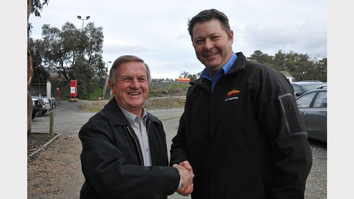 Stawell Gold Mines General Manager Troy Cole congratulates Ross Hatton, representing Stawell Regional Health, on receiving a community grant. Picture: BEN KIMBER