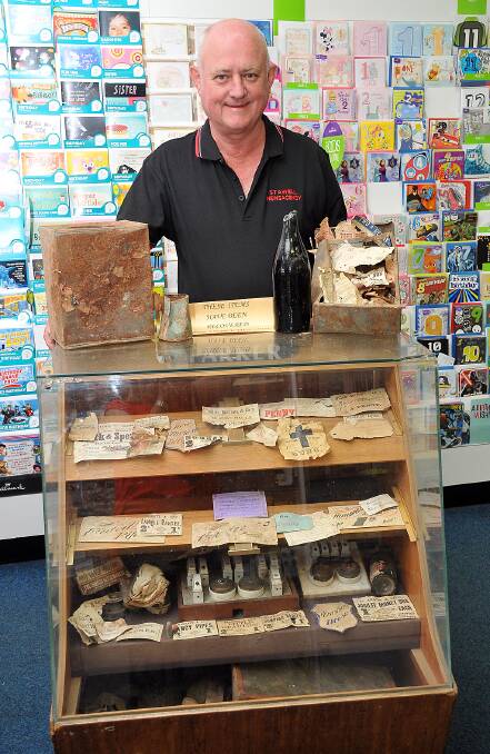 Ian Pappin with some of the old items now on display in the newsagency.