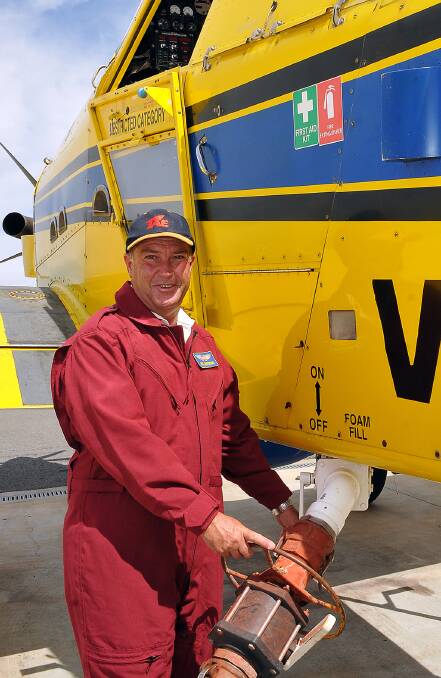 Don Armstrong fills one of the fixed wing fire bombing aircraft with water. 