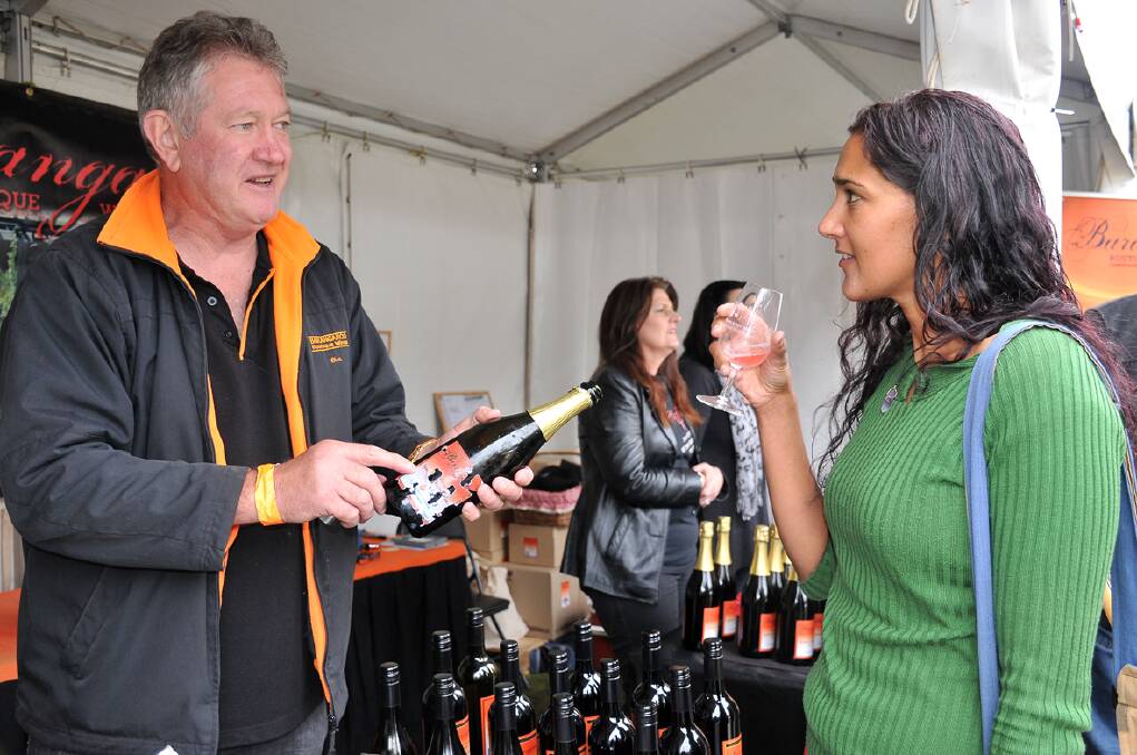 Chris McClure, from Barangaree Boutique Wines in Horsham, discusses a wine sample with Naline Pirani, of Halls Gap. 