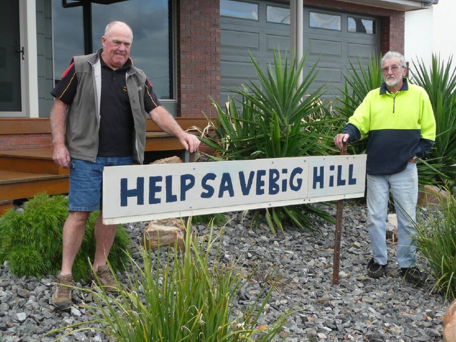Residents not just in Fisher Street, but across Stawell have been urged to erect signs in their front yards to help save Big Hill. Pictured are Geoff Blachford (left) and Rob Blight (right) with one of the signs that has sprung up in recent days. Picture: BEN KIMBER