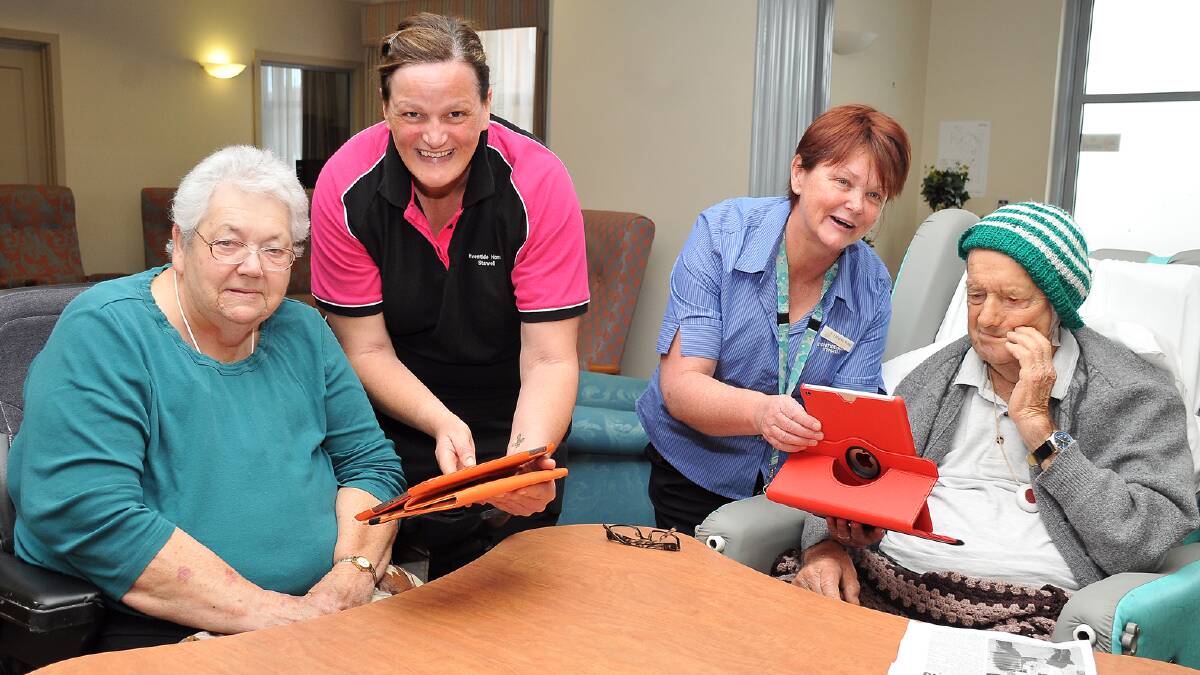 Eventide Homes residents, Marg and Rob McIntosh get their first look at the new IPads, with Andrea Monaghan and Leeanne Nuske. Picture: KERRI KINGSTON.