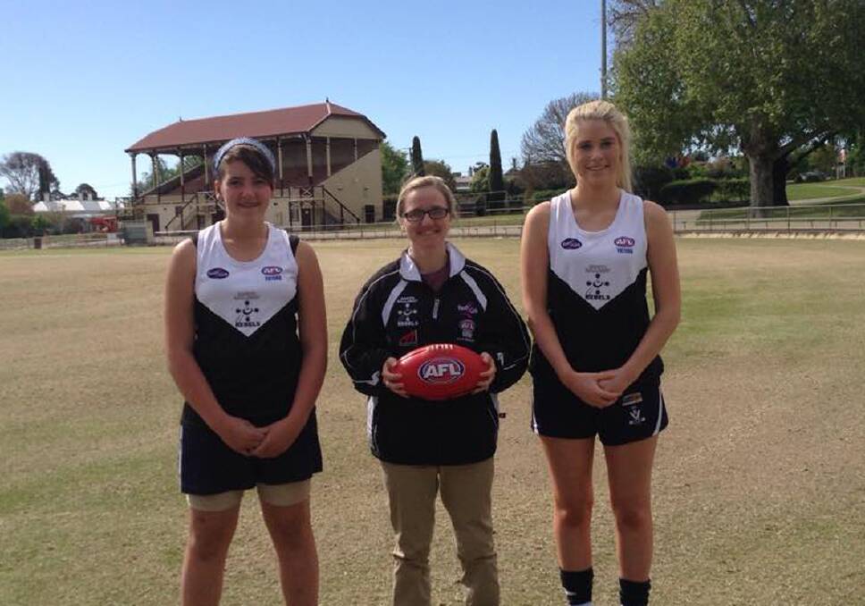 Rebels squad members Genevieve Blake (left) and Sarah Anderson (right) with Rebels coach Olivia Miocic.