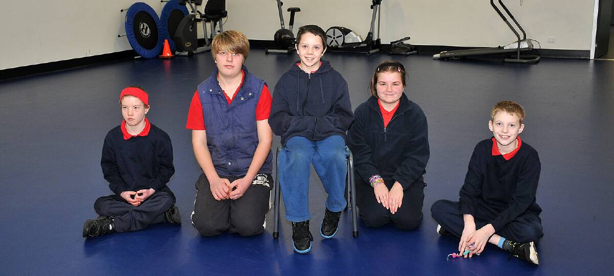 Students Mikayla, Jake, Blake, Jasmine and Hayden sit on the floor in the new multi purpose room at Skene Street, due to the lack of suitable chairs. A campaign has been launched to change all that. Picture: KERRI KINGSTON.