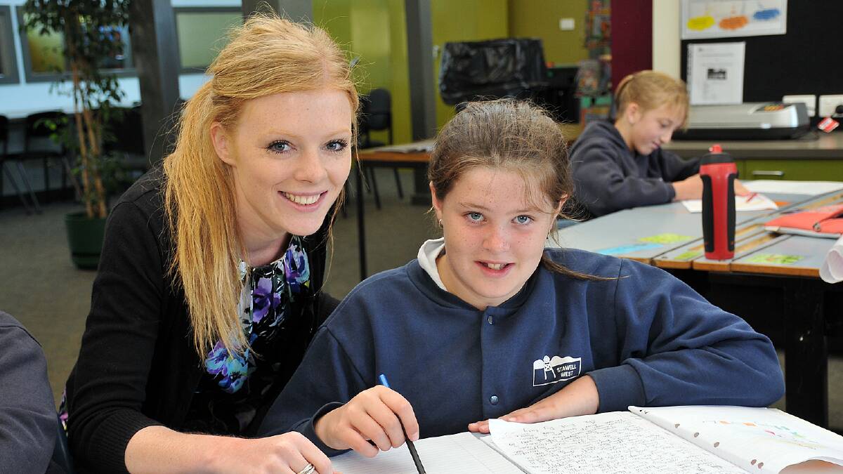 New teacher at Stawell West Primary School, Karisa Walker, works with with Lucy in the classroom. Picture: KERRI KINGSTON.