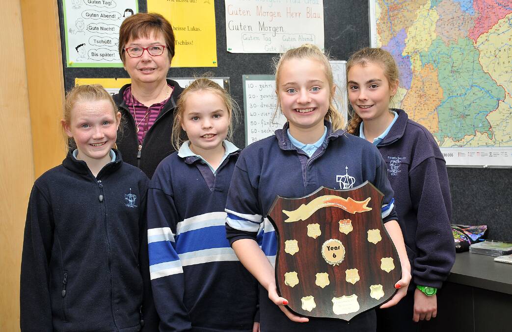 Stawell Primary School student, Laura Skinner, was successful in winning the state grade six German Poetry competition at the Austrian Club in Melbourne. Laura, pictured with the winning shield, was joined at the competition by German teacher Natalie Cooper and fellow students Tahlia, Leilanie and Olivia. Picture: KERRI KINGSTON.