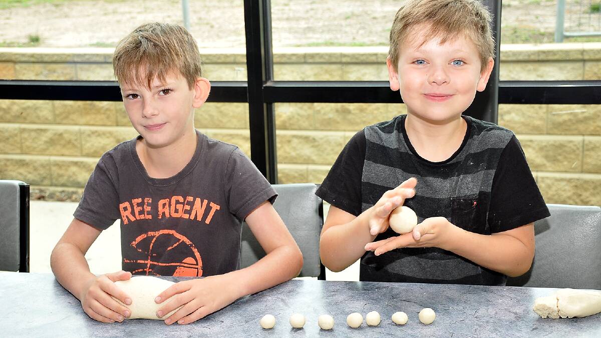 Kyle and Kayden are pictured making salt dough beads at the YMCA school holiday program at Stawell Primary School. Picture: KERRI KINGSTON.
