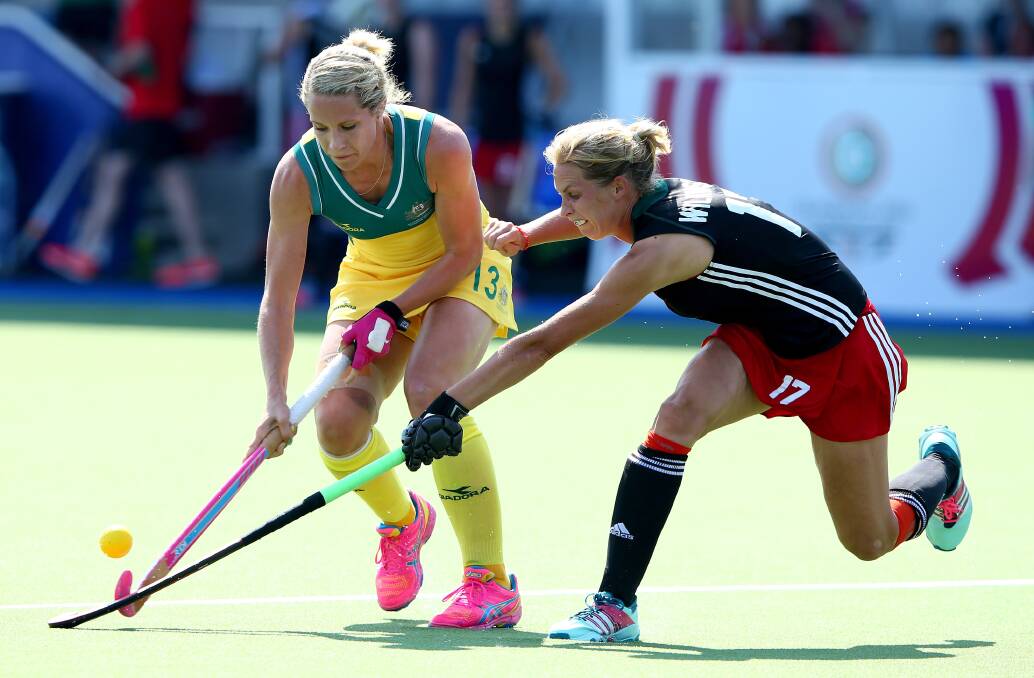 MILESTONE MOMENT: Australia's Edwina Bone keeps the ball away from the Wales in their Commonwealth Games match. Photo: GETTY IMAGES