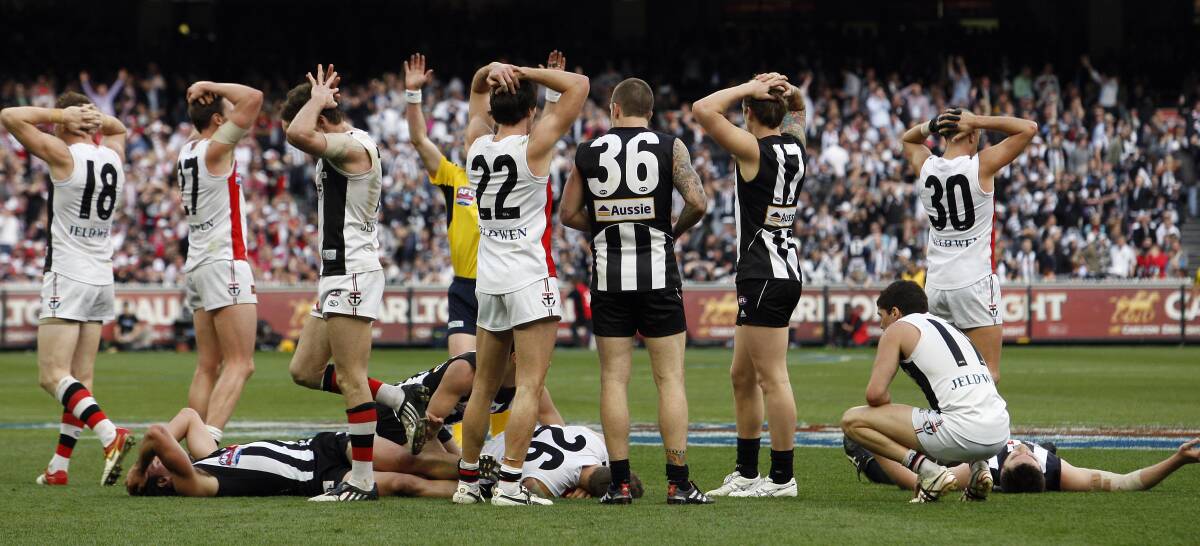 Collingwood and St Kilda players act in stunned disbelief when the final siren is sounded to confirm a draw. Fairfax photos.