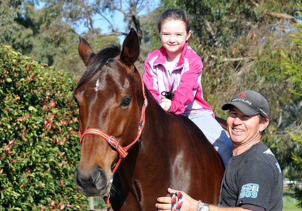 Dale Smith is pictured with Get Out Of Town and his seven-year-old daughter Jade.