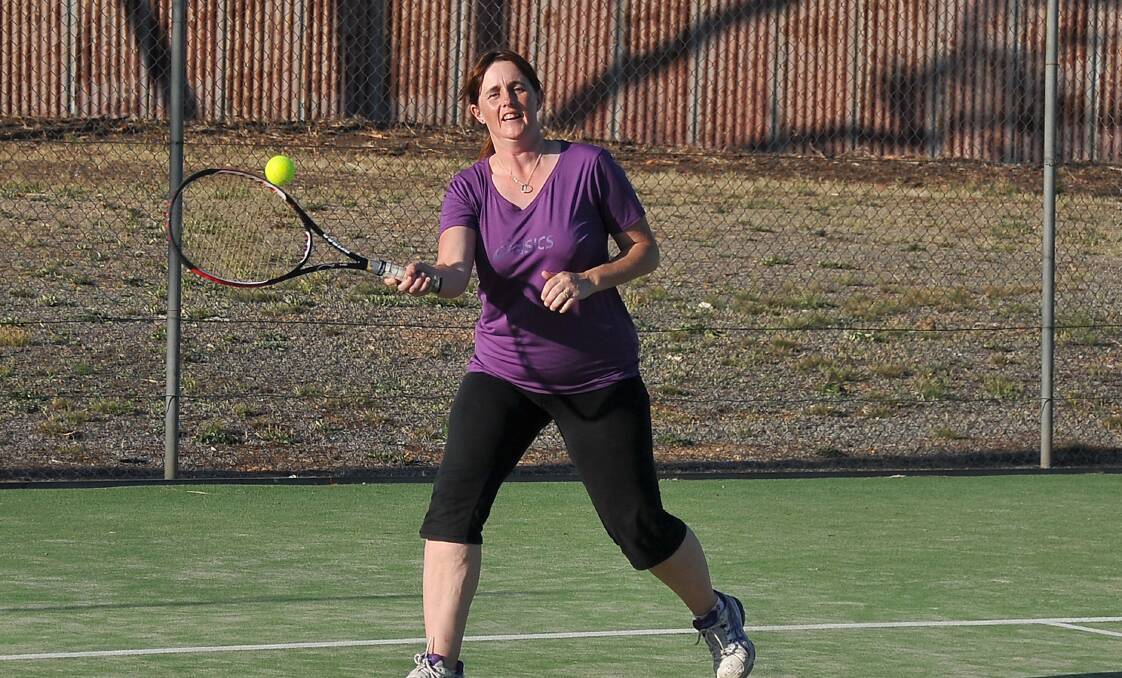 Christine Graveson works hard to return this shot in Stawell's Friday night tennis competition. Picture- MARK MCMILLAN