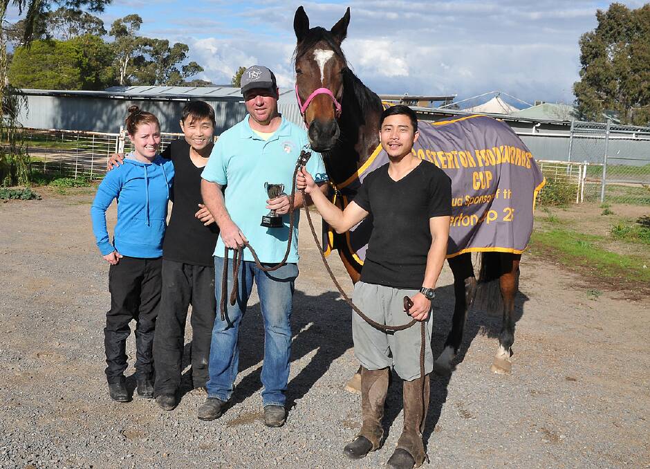 Winning jockey Chelsea is pictured with owners Smiley Chan, Jade Kennedy and Sam Mok as they proudly show off Casterton Cup winner Stable Star. Picture: Mark McMillan