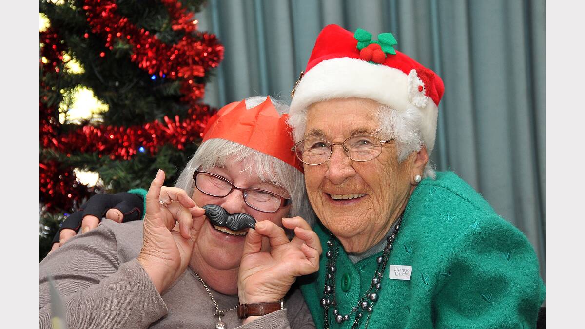 Brenda Clark and Doreen Duffy ham it up at the Probus Christmas in July celebrations.