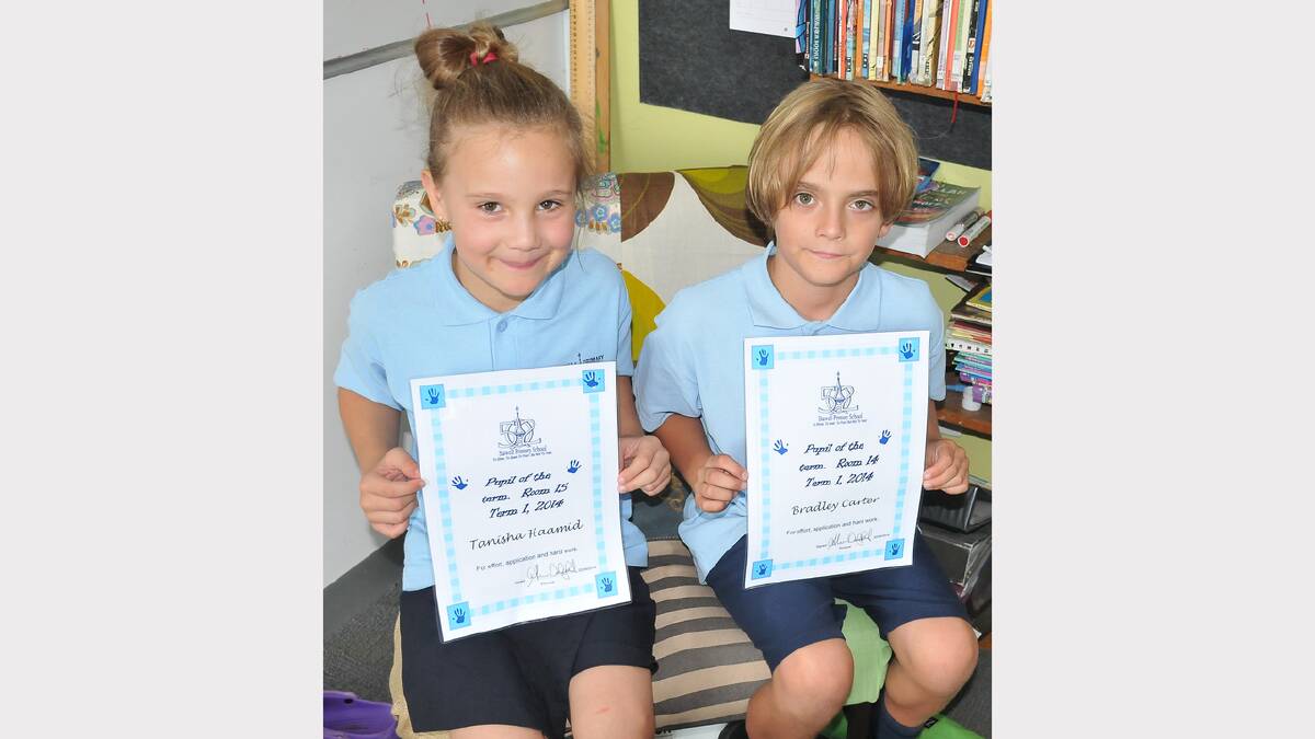Tanisha and Bradley proudly display their top pupil awards.