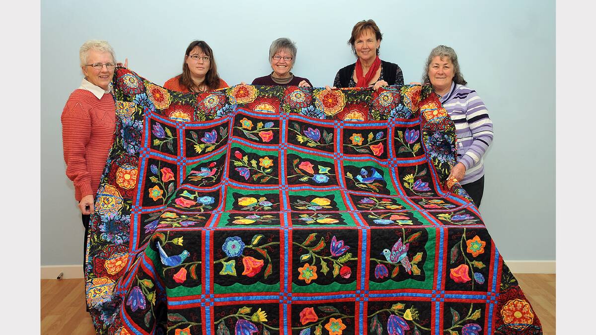 Pictured with the specially crafted quilt L-R Carole McGregor, Michele Kloester, Goog Rickard, Mandy Murphy and Pauline Holden.