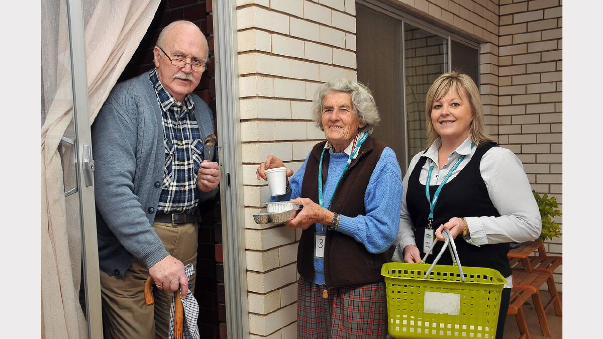 Stawell resident John Bevington receives his meal from volunteer Elva Raggatt and Northern Grampians Shire Council Meals on Wheels coordinator, Shirley Rickard.