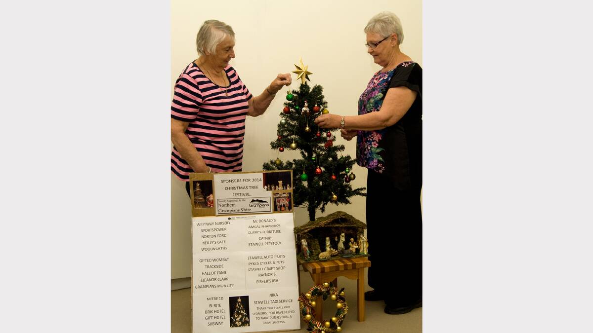 Val Vansfield and Jo Bertram prepare a Christmas Tree for this weekend's festival.