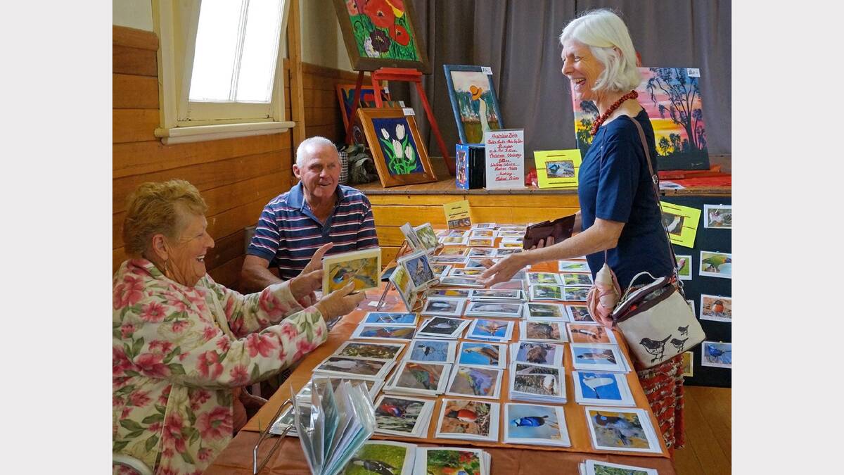 Barb Jenkins, with her husband Ned, shows a customer her range of decorated cards.