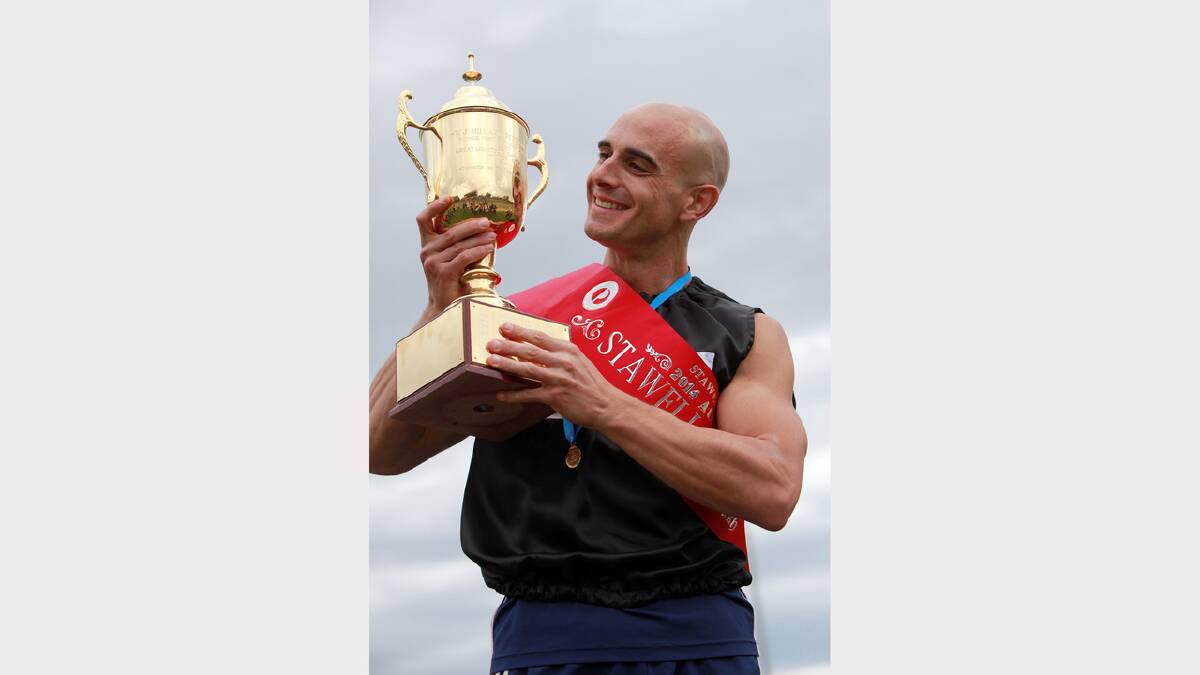 Stawell Gift winer Luke Versace admires the Stawell Gift trophy.
