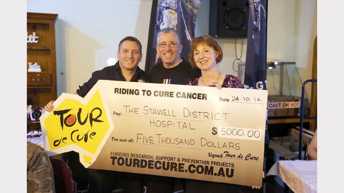 Chris and Paul Egan present a cheque for $5000 to Stawell Regional Health chief executive officer Liz McCourt.