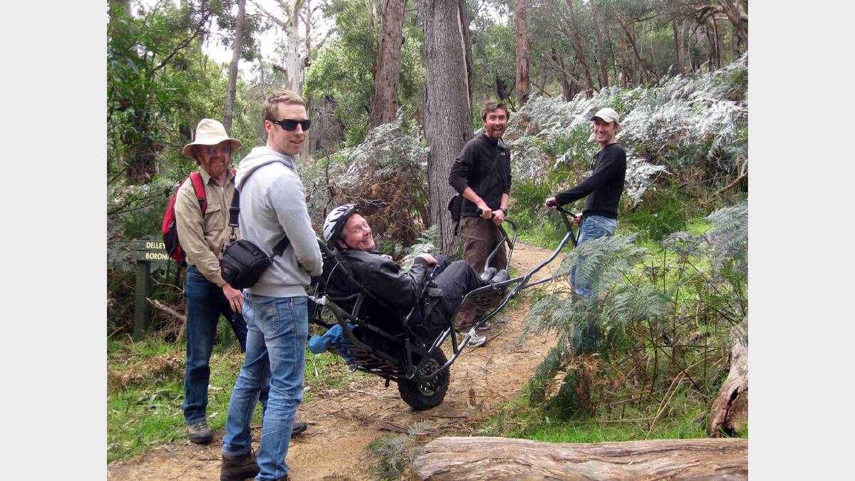 Dr David Stratton in the Trailrider helped up to Boronia Peak by Ben, Josh, Flynn and Rodney.