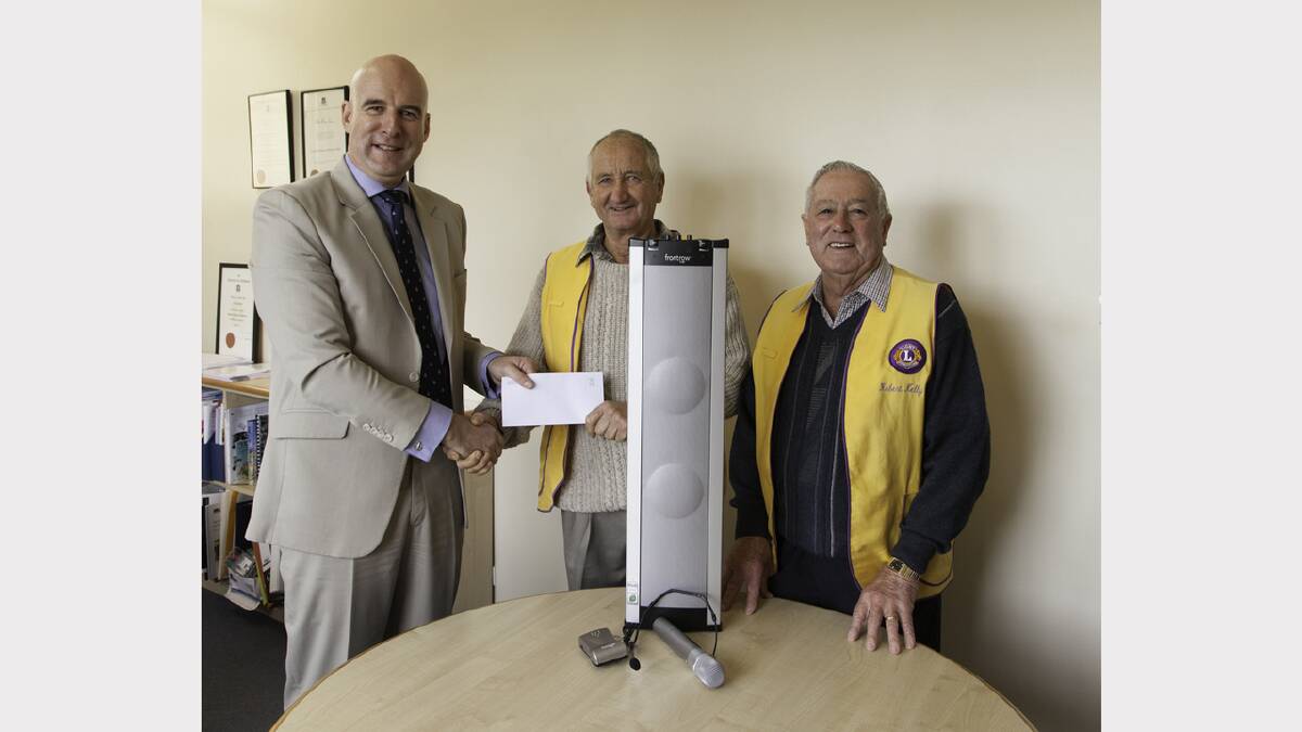 Stawell Secondary College principal Colin Axup, accepts the donation from Stawell Lions Club president Scot Fletcher and treasurer Robert Kelly.