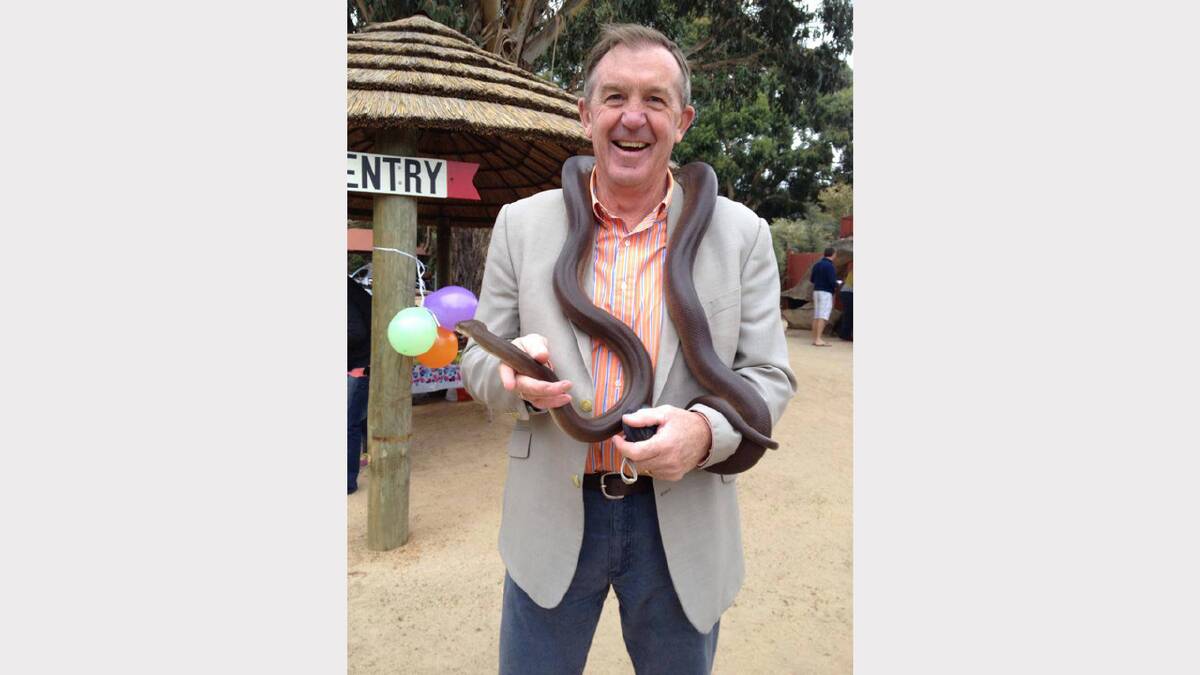 Nationals Member for Lowan Hugh Delahunty holds a python during the opening of new facilities at the Halls Gap Zoo.