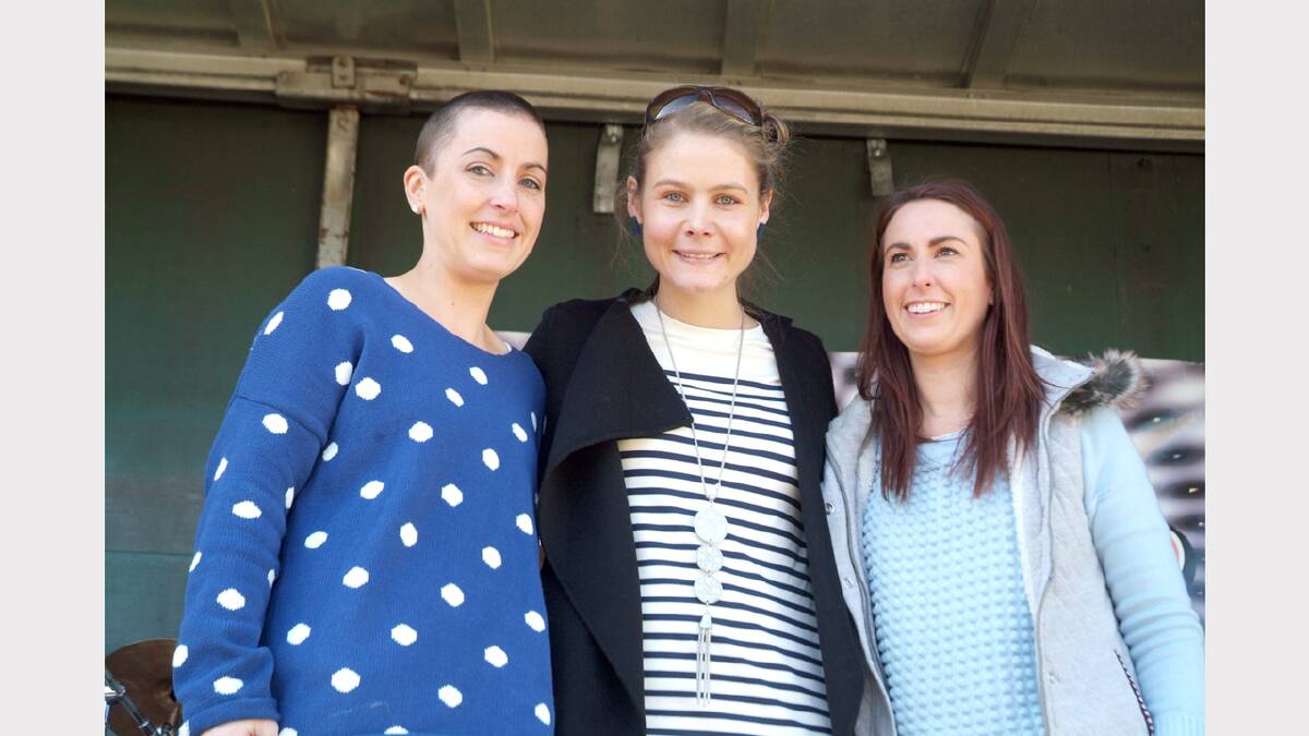 Belinda Scott is flanked by Bree Pickering (left) who shaved her head at the fun day and Calinda Sinnot-Barker, who took the clippers to Bree in front of the big crowd.