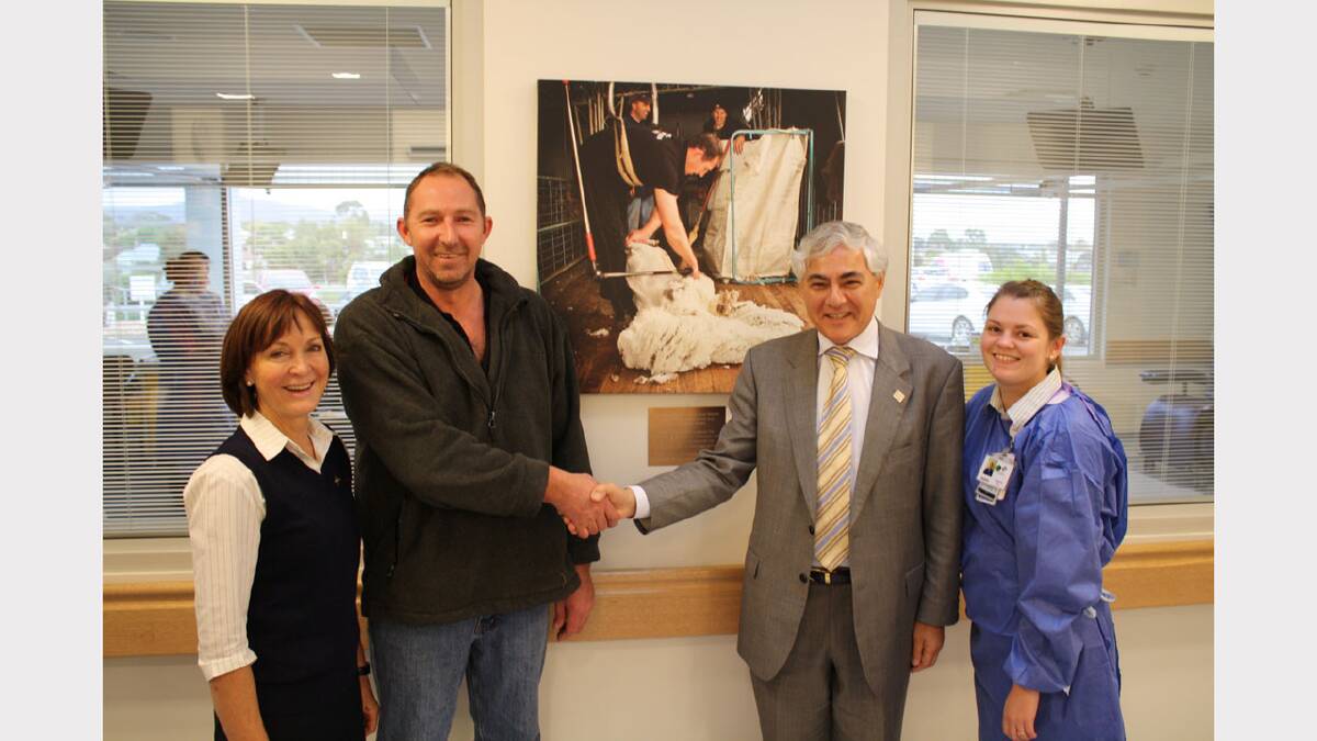 L-R Lyn Bibby, Aaron Hemley, Professor George Kannourakis and Sarah Pridham with the canvas and plaque at the oncology centre.