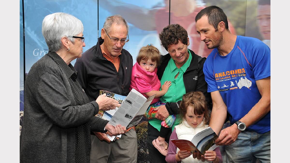 Lois Nuske talks about attractions around Stawell to Allan and Bernadette Franzki of Melbourne, with their son Ian and granddaughters Bethany and Rosie.