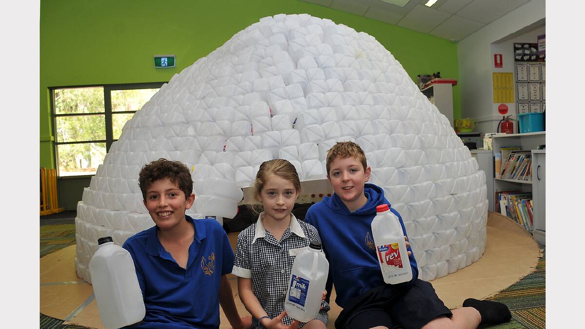 Students Eugene, Alesha and Dylan with the igloo at Halls Gap Primary School.
