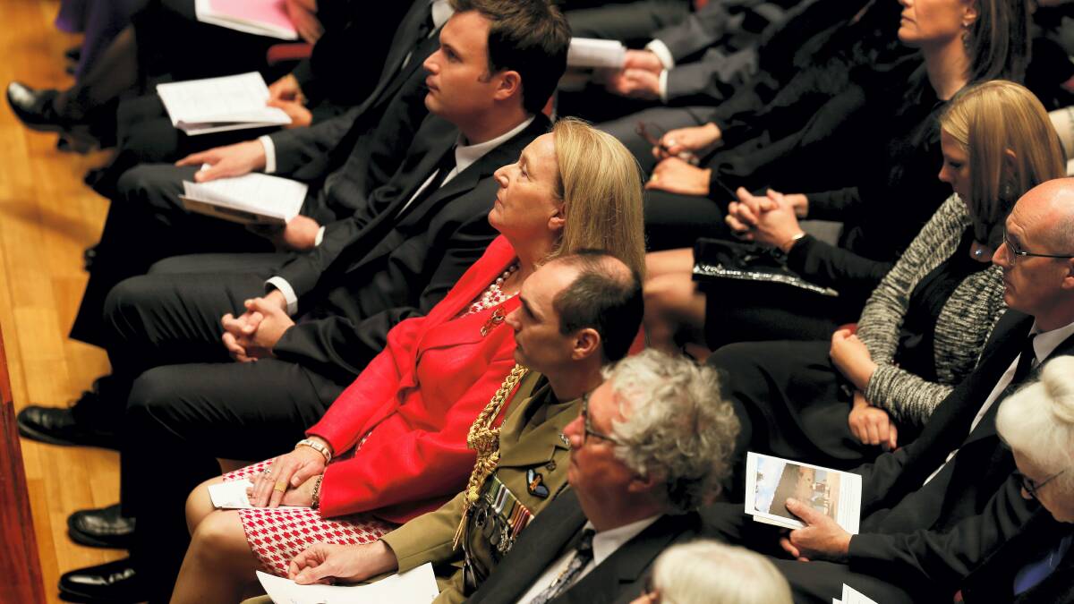 Frances Underwood with son William (to her left) at the state funeral service for the late governor, Peter Underwood. 
