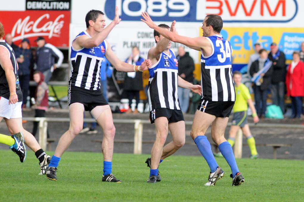 THE BUSINESS: Clint Midgley, Liam Newell and Tom Delahunty celebrate a goal in the 2016 grand final. Midgely wants to give the supporters something to celebrate on Saturday.