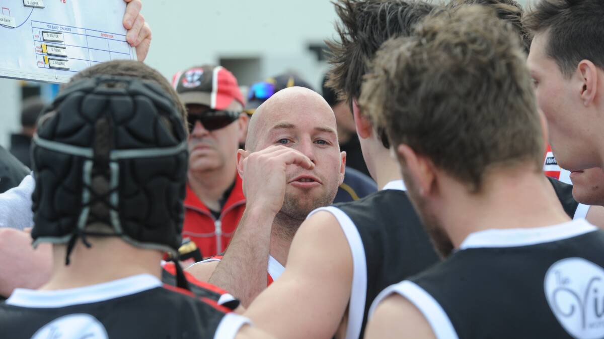 LEADER: Horsham Saints coach Luke Fisher delivers instructions to his charges during the quarter-time break. Fisher's side kept its premiership defence alive with the victory over Stawell. Picture: STUART MCGUCKIN