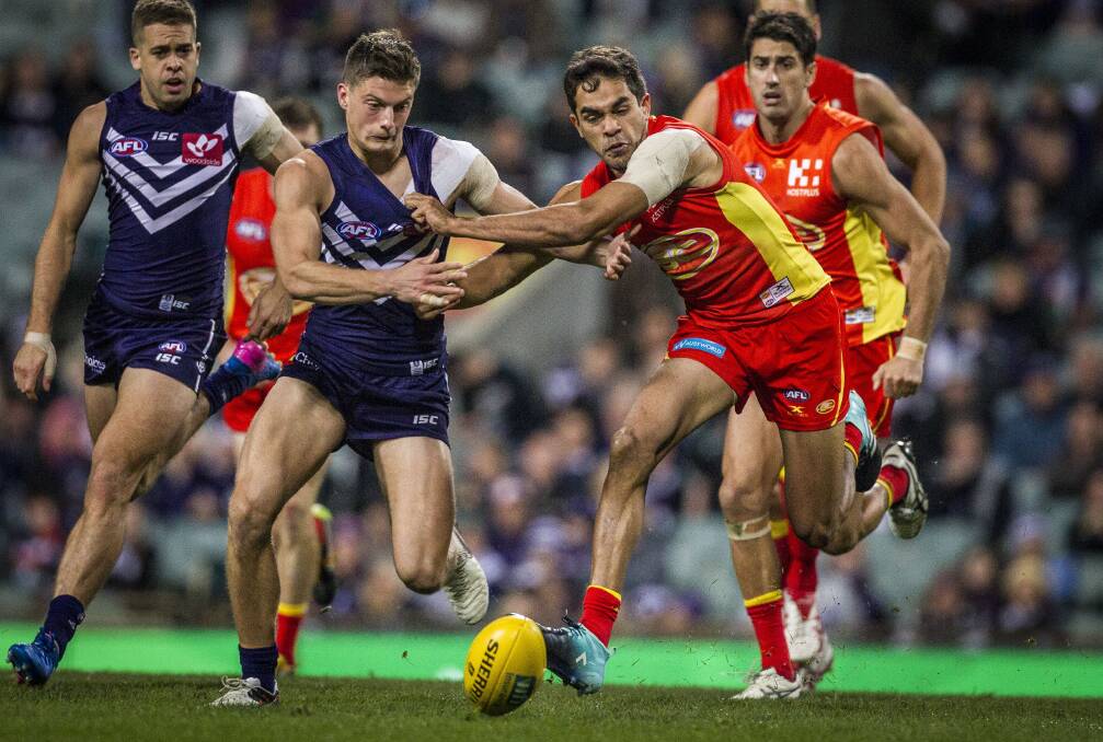 NEW DEAL: Darcy Tucker battles against Jack Martin as the pair hunt a loose ball during the round 20 match between Fremantle and Gold Coast. Tucker has re-signed with Fremantle until the end of the 2019 season. Picture: AAP IMAGE