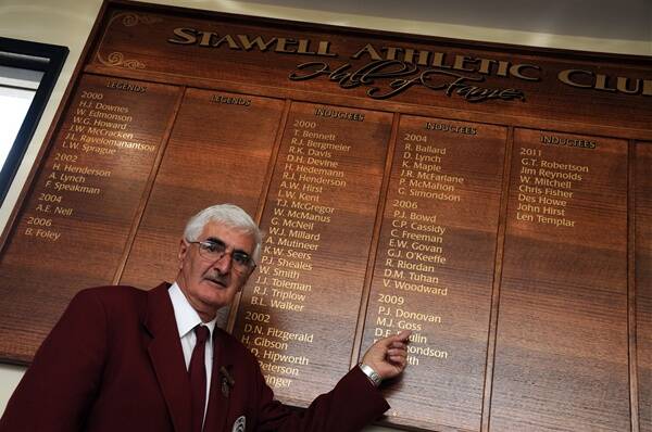 Peter Donovan pointing to his name on the Stawell Athletic Club's Hall of Fame honour board.