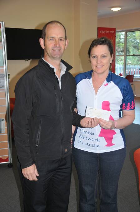 Michael Kelly presents Kerri Skene with a $200 cheque to assist with her charity bike ride in February.